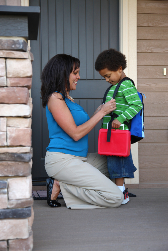 Mother gets child ready for first day of school